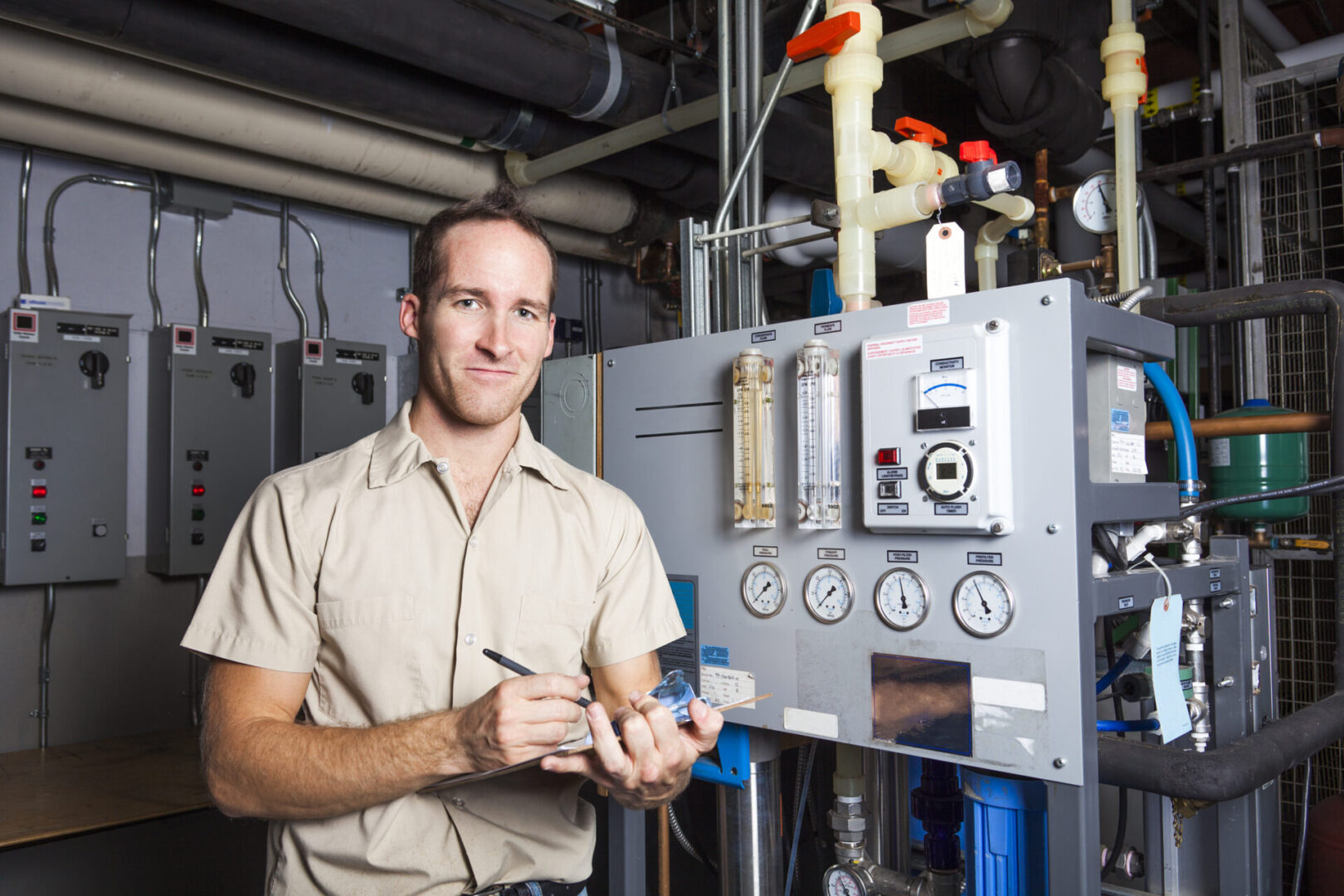 A Technician inspecting heating system in boiler room